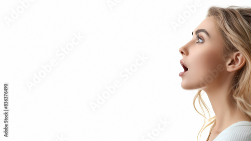 Close up profile of a young Caucasian woman with mouth open wide, shouting. Isolated on white, copy space, aspect ratio 16:9