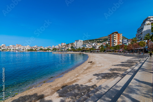 A view along the beach in the bay at Sarande in the morning in summertime © Nicola