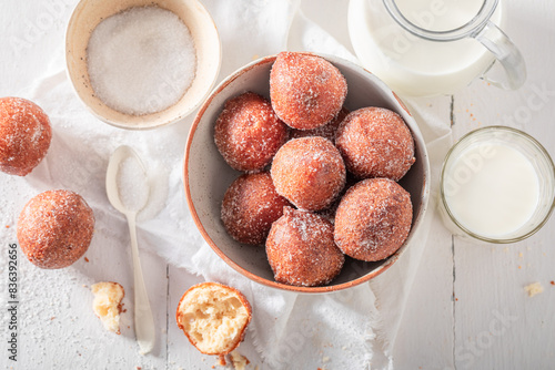 Hot and homemade mini doughnuts with milk and caster sugar. photo