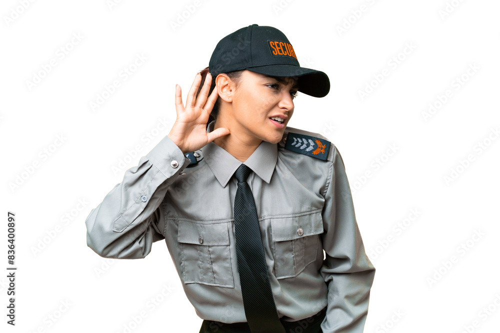 Young safeguard woman over isolated chroma key background listening to something by putting hand on the ear Young safeguard woman over isolated chroma key background listening to something by putting hand on the ear