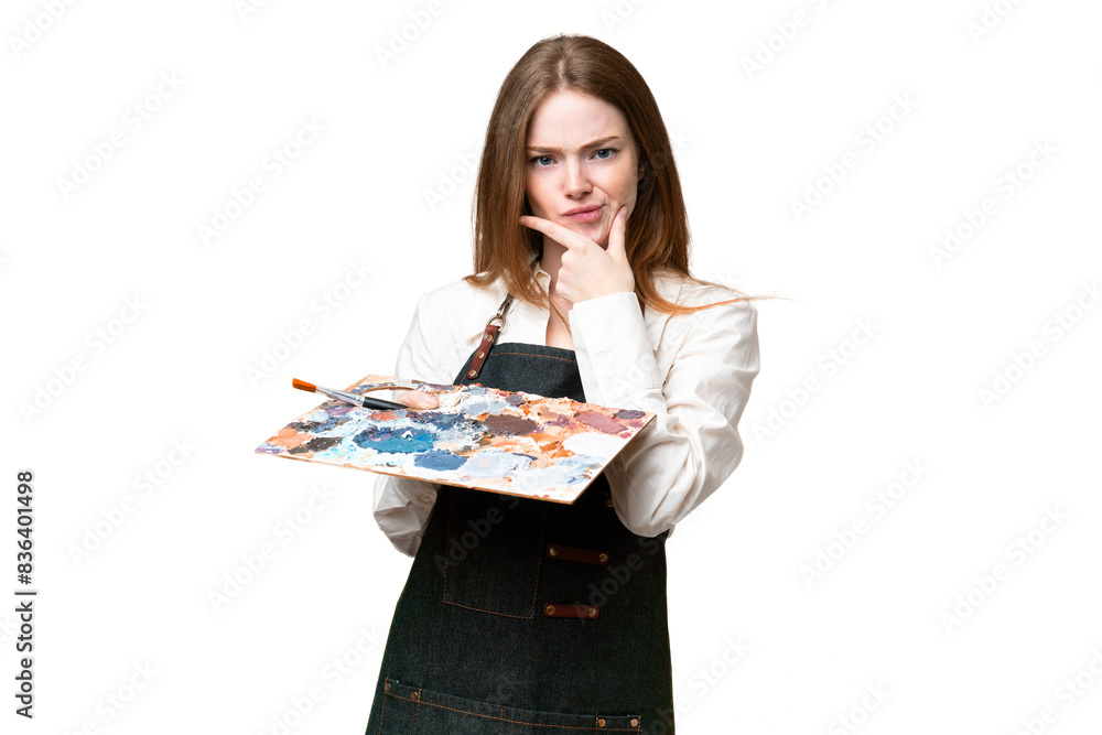 Young artist woman holding a palette over isolated chroma key background thinking Young artist woman holding a palette over isolated chroma key background thinking