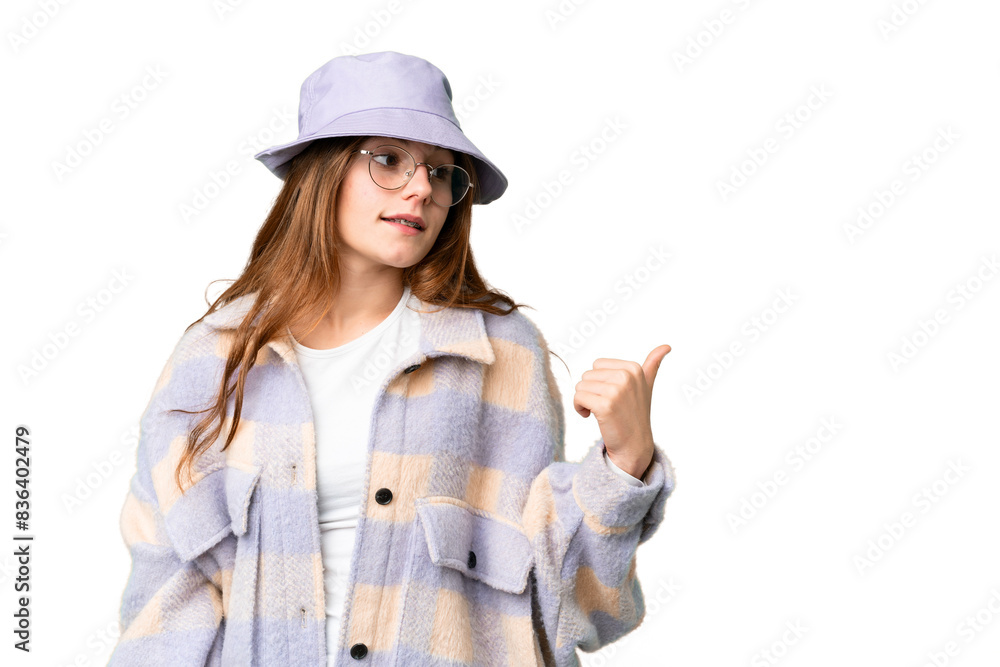 Teenager girl over isolated chroma key background pointing to the side to present a product Teenager girl over isolated chroma key background pointing to the side to present a product