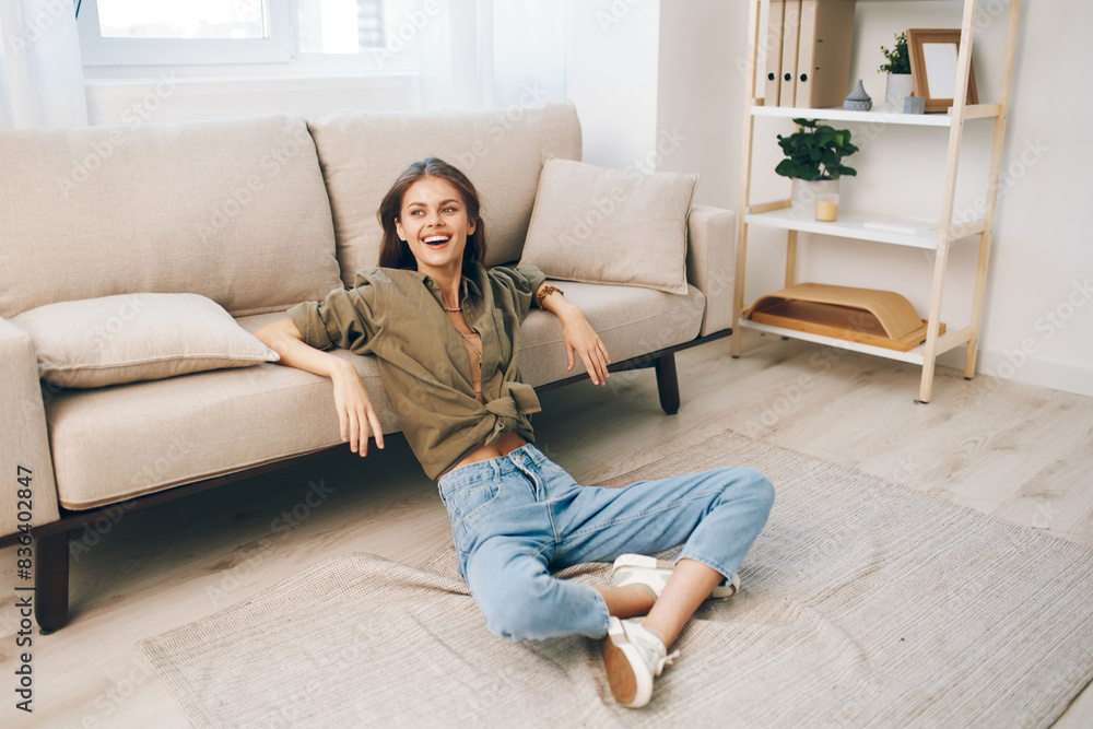 Happy Woman Relaxing on Cosy Sofa in Modern Apartment Happy Woman Relaxing on Cosy Sofa in Modern Apartment