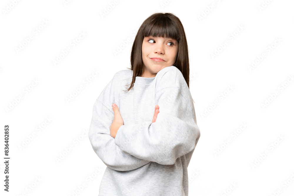 Little girl over isolated green chroma key background making doubts gesture while lifting the shoulders Little girl over isolated green chroma key background making doubts gesture while lifting the shoulders