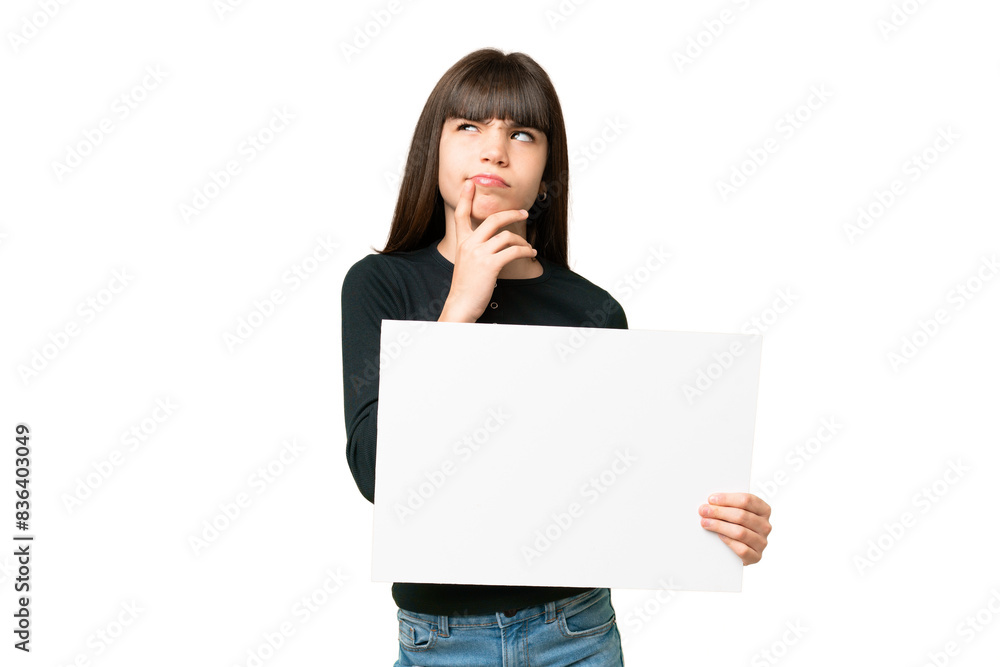 Little girl over isolated chroma key background holding an empty placard and thinking Little girl over isolated chroma key background holding an empty placard and thinking