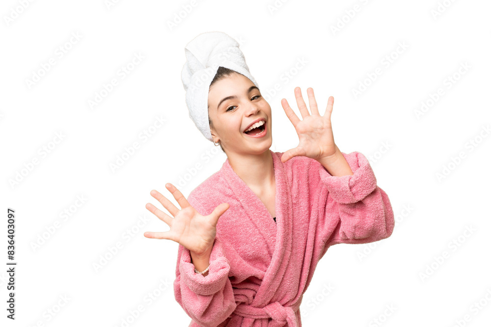 Little girl in a bathrobe over isolated chroma key background counting ten with fingers Little girl in a bathrobe over isolated chroma key background counting ten with fingers