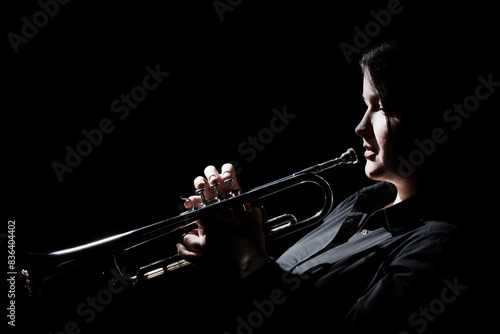 Trumpet player. Woman playing brass instrument