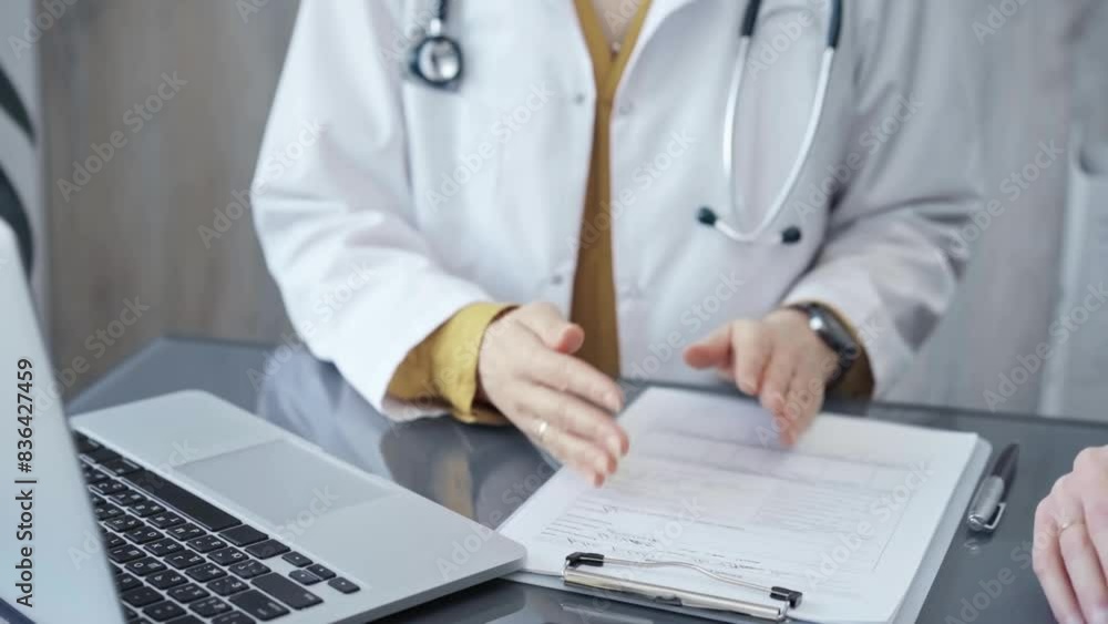 Doctor is talking with patient. Close-up of a doctor's hands gesturing above the table in medical office. Medicine and health care concept Doctor is talking with patient. Close-up of a doctor's hands gesturing above the table in medical office. Medicine and health care concept