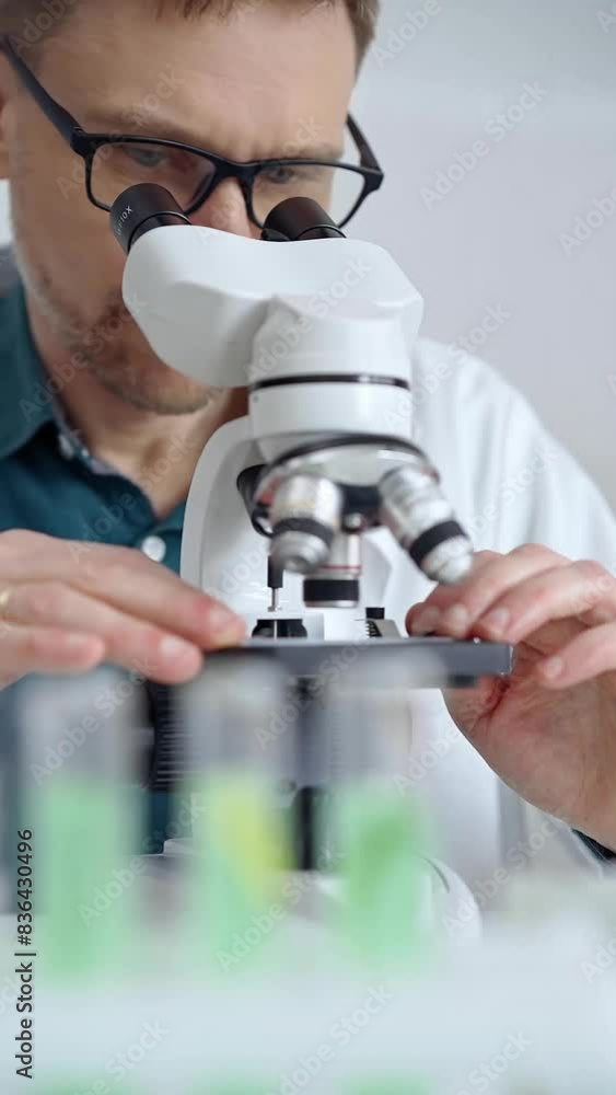 Man scientist using microscope in laboratory. Microbiology science concept Man scientist using microscope in laboratory. Microbiology science concept