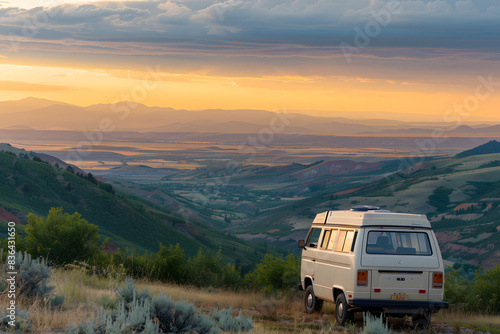 Scenic Sunset View of Vintage Camper Van Overlooking Rolling Hills and Serene Valleys