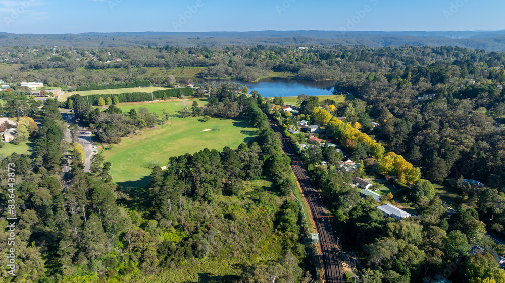 Drone aerial photograph of the mountains train line running towards Wentworth Falls Lake in the Blue Mountains in NSW, Australia. Drone aerial photograph of the mountains train line running towards Wentworth Falls Lake in the Blue Mountains in NSW, Australia.