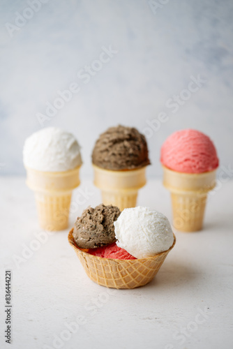 vanilla, chocolate, strawberry ice creams on cone