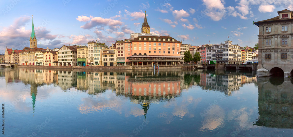 Naklejka premium Panoramic view of Zurich waterfront with reflections of Fraumunster and St Peters Church, Switzerland