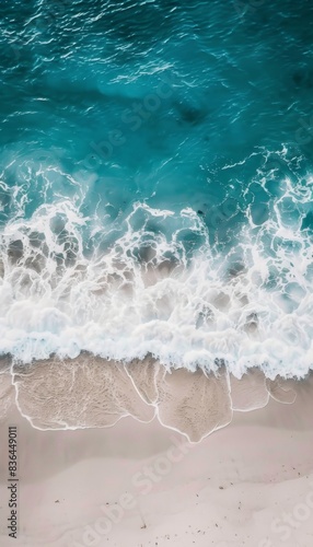 Sandy beach and soft blue ocean wave top view. Summer background