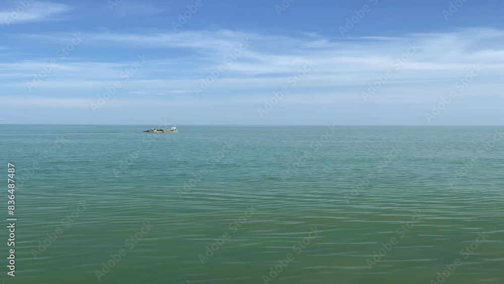 Beautiful view with a row of small fishing boats in the distance in the afternoon with a blue sky in the background in Central Java, Indonesia Beautiful view with a row of small fishing boats in the distance in the afternoon with a blue sky in the background in Central Java, Indonesia