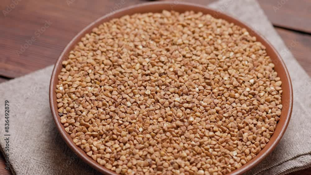 Dry Buckwheat Grains on Clay Plate, Close-Up Shot Dry Buckwheat Grains on Clay Plate, Close-Up Shot