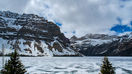 snow covered mountains on lake