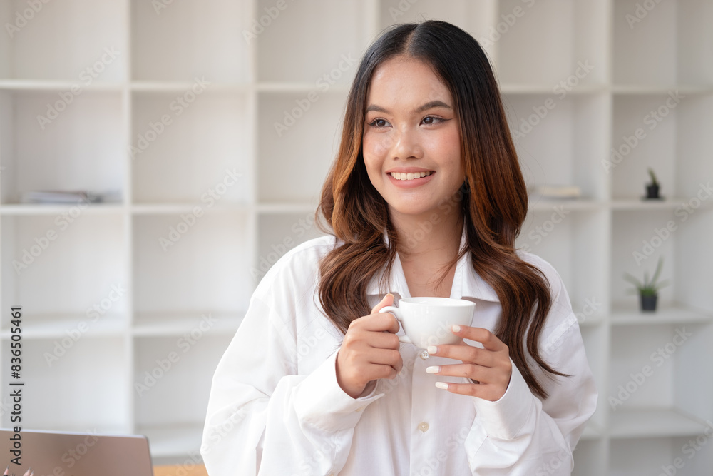 Businesswoman using laptop at cafe while drinking coffee, Relaxing holiday concept. Businesswoman using laptop at cafe while drinking coffee, Relaxing holiday concept.