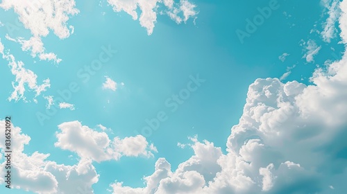 Light blue sky with fluffy white clouds  offering plenty of room for text