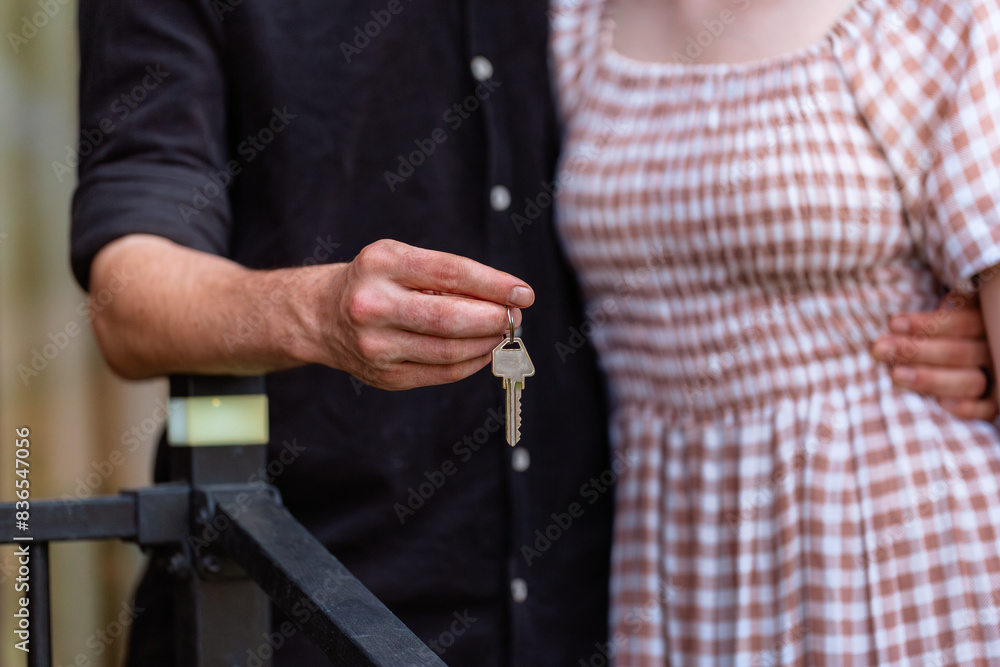 House key in hand of young homebuyer couple House key in hand of young homebuyer couple