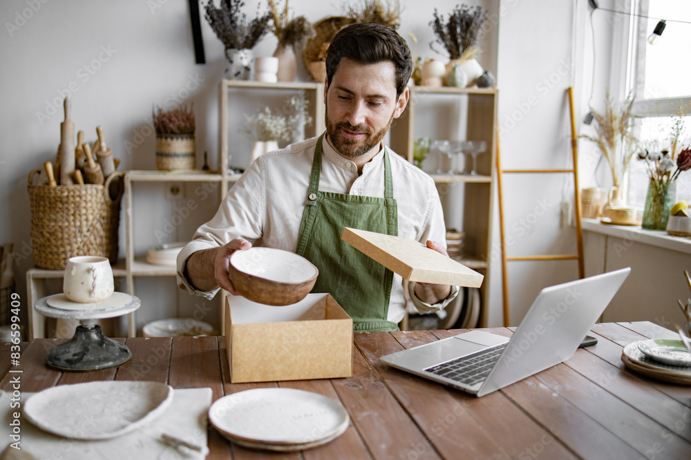 Entrepreneur sells dishes, plates and cups made of clay, ceramics online and packs them in boxes for sending to the delivery service. Small business selling goods on the Internet. Entrepreneur sells dishes, plates and cups made of clay, ceramics online and packs them in boxes for sending to the delivery service. Small business selling goods on the Internet.