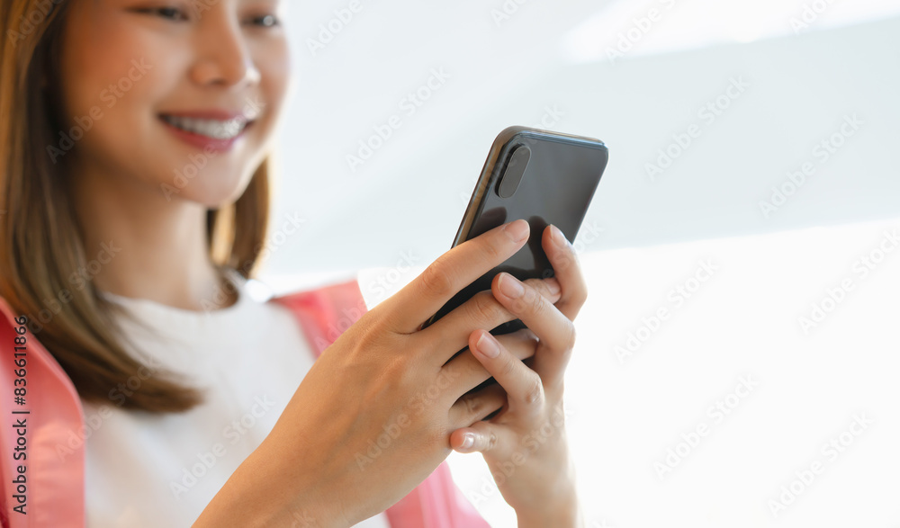 Woman using smartphone in public areas, During leisure time. The concept of using the phone is essential in everyday life. Woman using smartphone in public areas, During leisure time. The concept of using the phone is essential in everyday life.