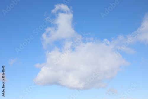 towering white cloud with vertical development in the clear blue foreign sky indicating serene weather