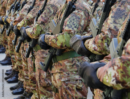 platoon of soldiers with green and brown camouflage uniform with black gloves and assault rifle in hand