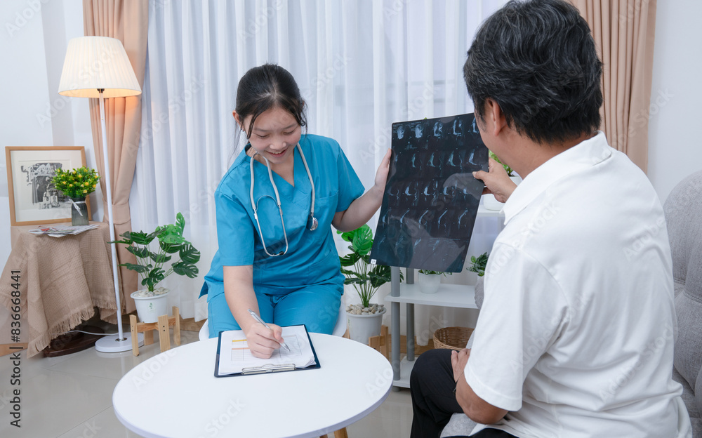 Doctor or nurse examines, explains x-ray results and takes treatment notes for an elderly man at the hospital. Doctor or nurse examines, explains x-ray results and takes treatment notes for an elderly man at the hospital.