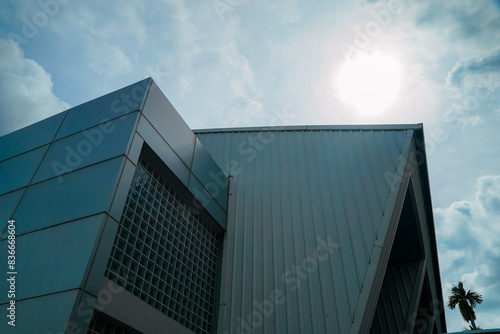 A large building with a lot of windows and a metal roof