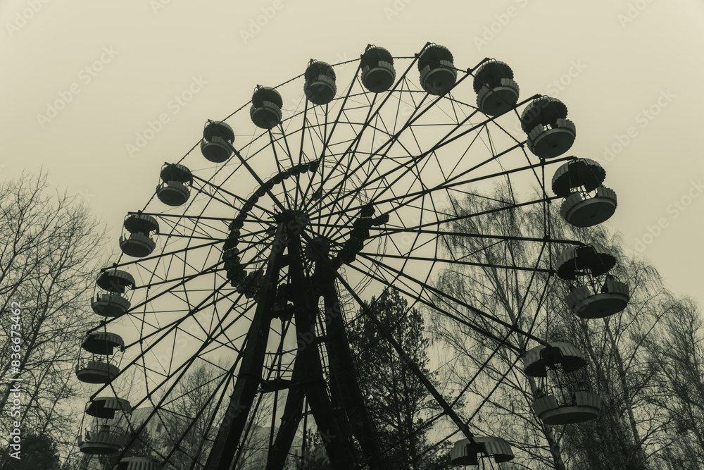 Ferris wheel in abandoned amusement park in a ghost town Pripyat, Ukraine. Chornobyl exclusion zone Ferris wheel in abandoned amusement park in a ghost town Pripyat, Ukraine. Chornobyl exclusion zone
