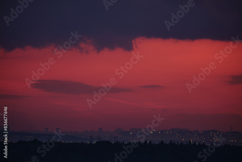 Nature s twilight show painted the evening skyline with deep reds and soft oranges above the city s roofs.