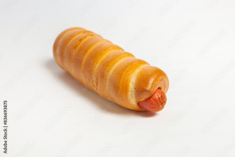 Sausage in the dough isolated on a white background. Sausage in the dough isolated on a white background.