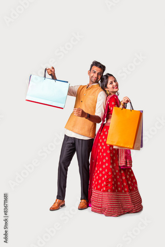 Indian asian young couple wears traditional cloths holding diwal photo