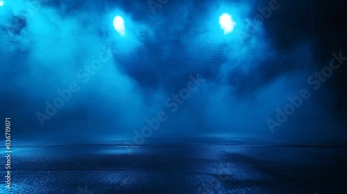 Misty urban scene with blue lighting, fog, and a wet, reflective pavement surface. The atmosphere is eerie and mysterious. © Natalia