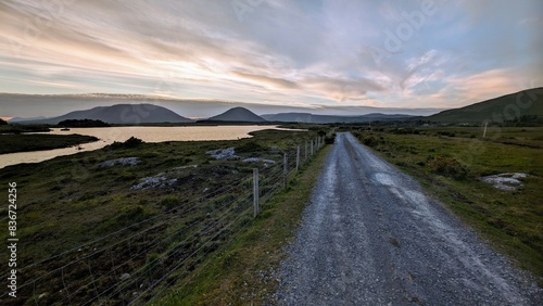 Obraz na płótnie Empty rural road by lake and mountains at Connemara national park, Galway, Ireland w salonie