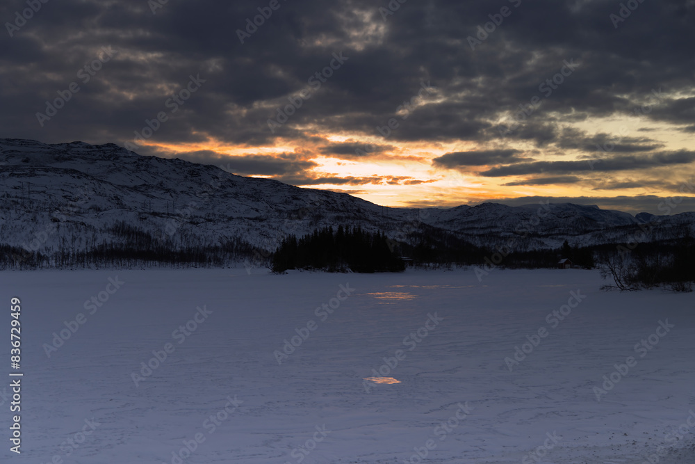 Fototapeta premium a view of a frozen lake with mountains in the background