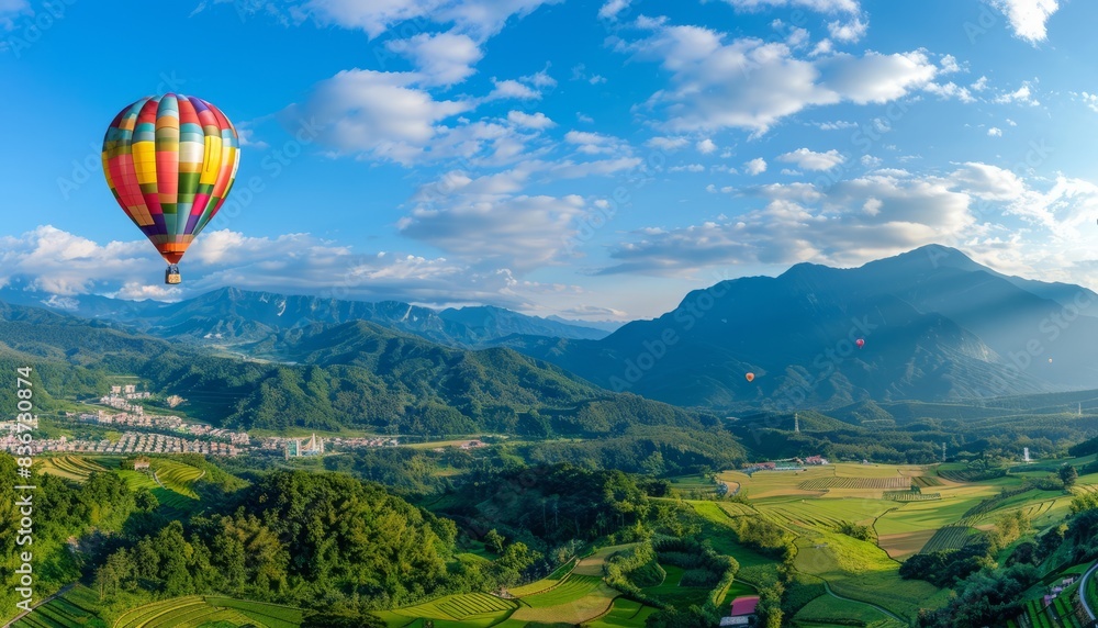 Fototapeta premium Panoramic Paradise: Hot Air Balloons Soar over the Mountain Views of Cingjing Farm, Taiwan