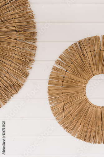 Decorative straw plates on white wall. Modern minimal home interior design