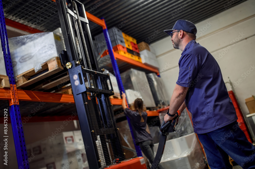 Cheerful man working in warehouse of grocery store or restaurant Cheerful man working in warehouse of grocery store or restaurant