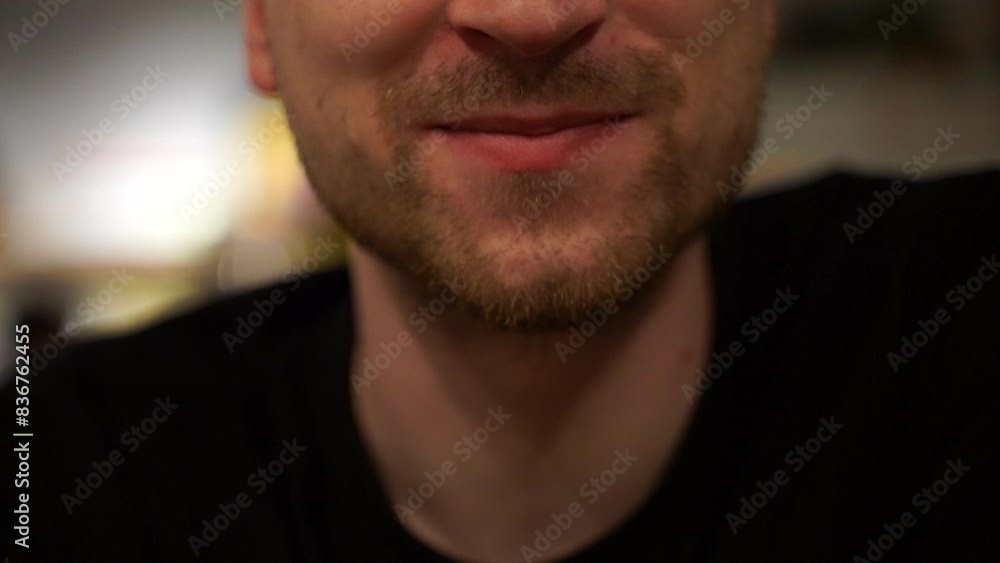Young man wiping his lips with a napkin after eating, cropped shot without face, a person wipes their mouth with a yellow napkin after eating a mea Young man wiping his lips with a napkin after eating, cropped shot without face, a person wipes their mouth with a yellow napkin after eating a mea