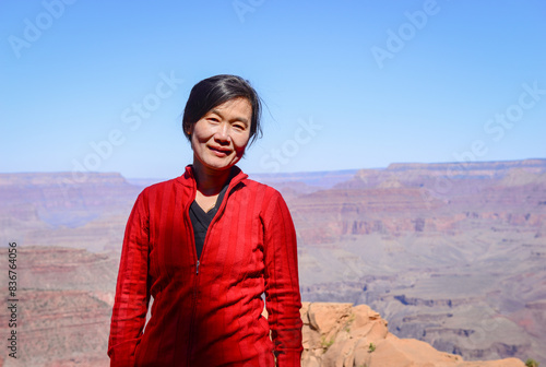 Female tourist posing for photos at Grand Canyon National Park. Arizona. USA.