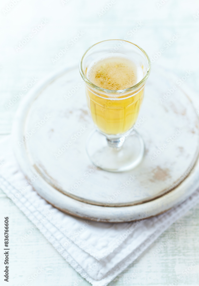 Glass of beer on bright wooden background. Copy space.
Glass of beer on bright wooden background. Copy space.