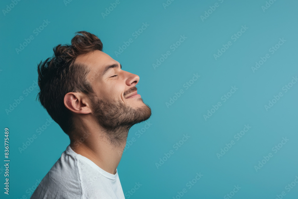 A close up of a man with beard and closed eyes looking to a side A close up of a man with beard and closed eyes looking to a side