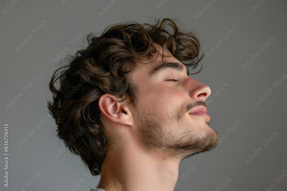 Fototapeta premium A close up of a man with beard and closed eyes looking to a side
