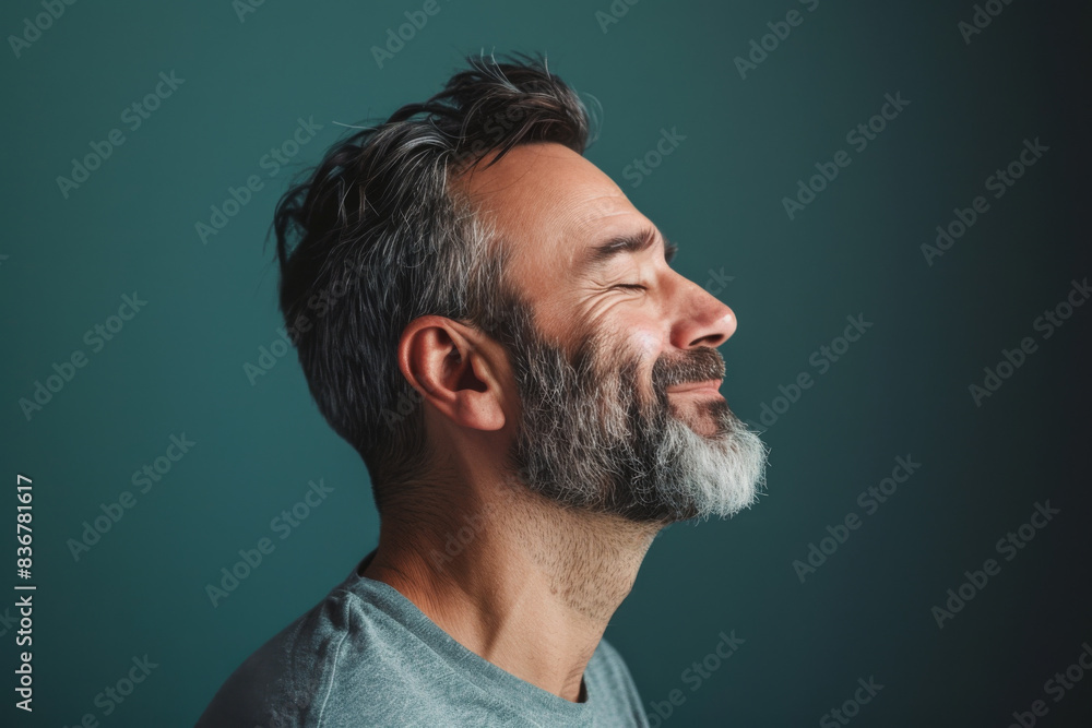 Fototapeta premium A close up of a man with beard and closed eyes looking to a side