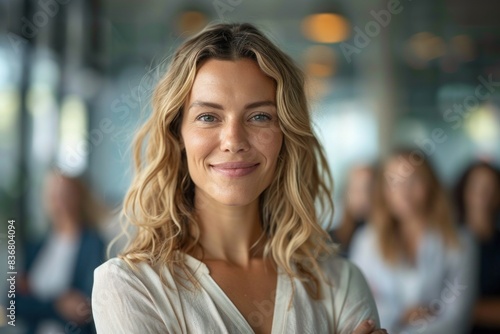 Confident and friendly professional woman smiling in a closeup with a blurred office background, ideal for corporate and motivational concepts Free Download Confident and friendly professional woman smiling in a closeup with a blurred office background, ideal for corporate and motivational concepts - GFXLoad