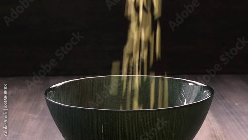 whole rice falling into a bowl, video