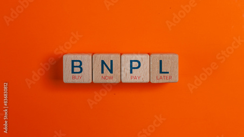 BNPL text in wooden blocks. Buy now pay later concept. Copy space