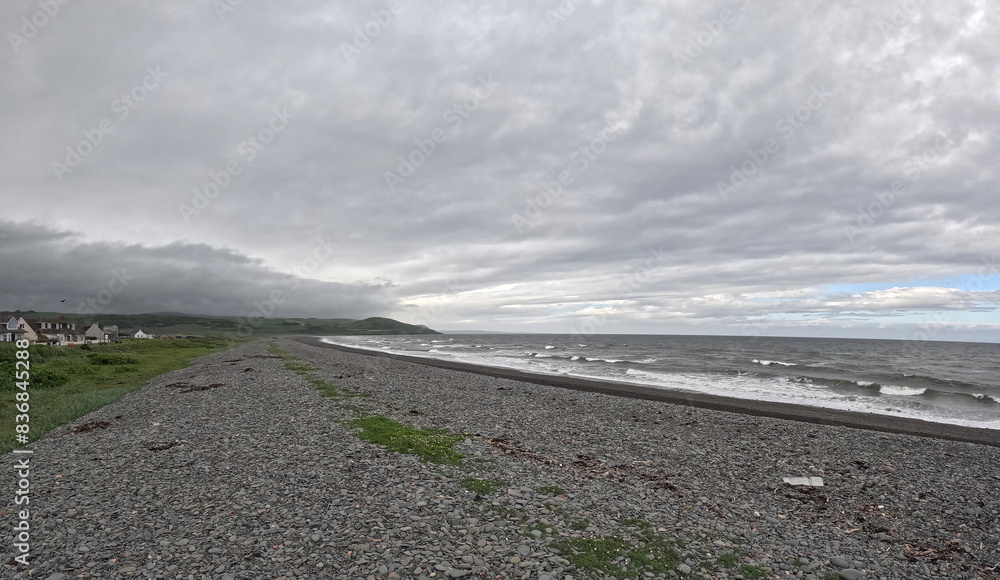 Rocky beach under cloudy sky with scattered leaves in Ballantrae, Ayrshire, Scotland, UK Rocky beach under cloudy sky with scattered leaves in Ballantrae, Ayrshire, Scotland, UK